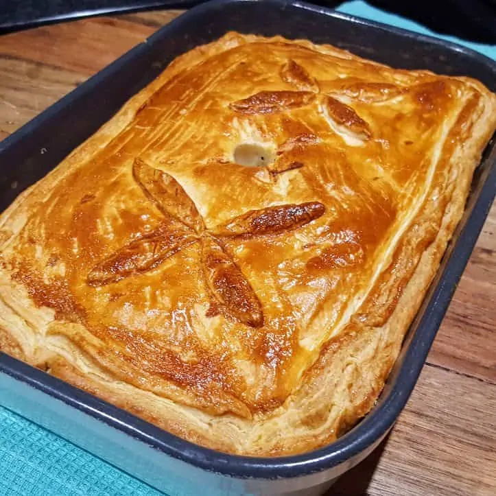 Golden homemade pie in a baking dish